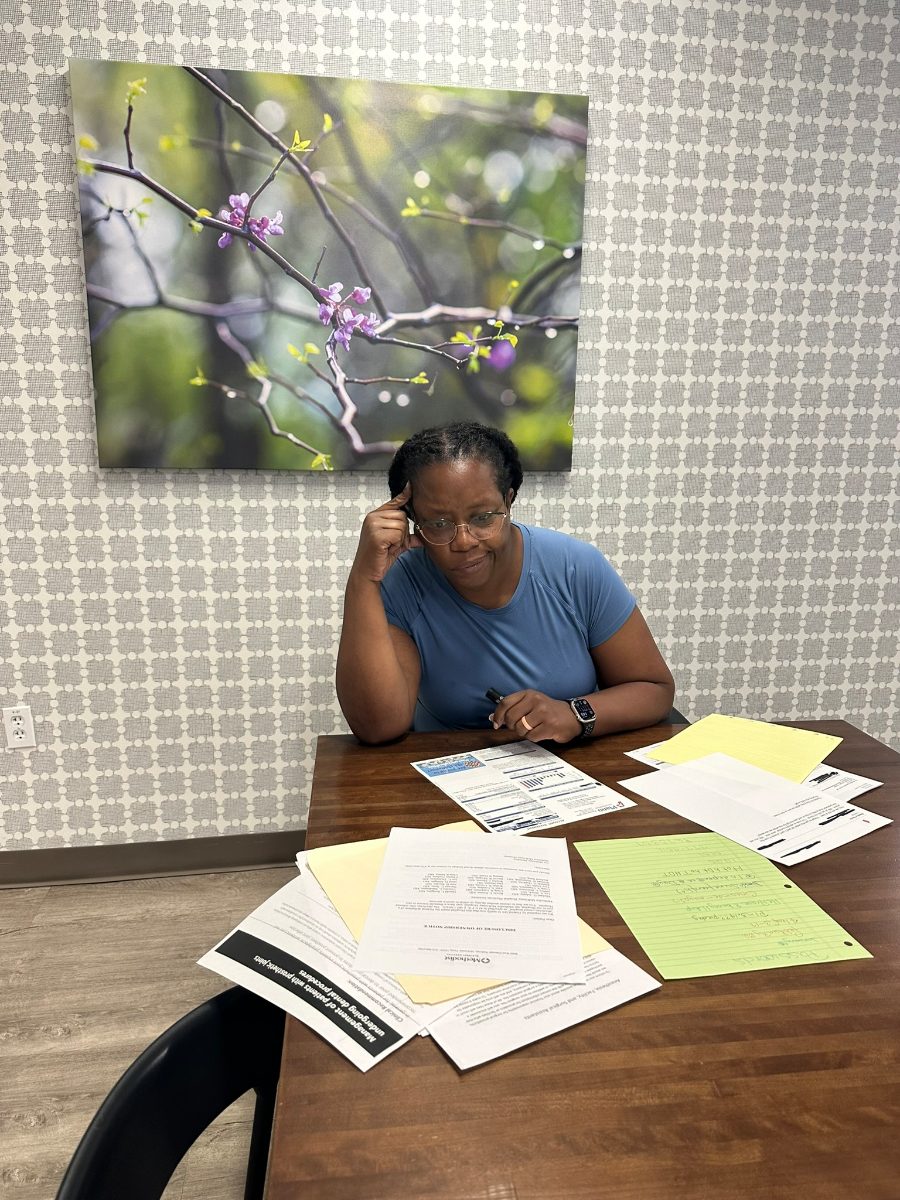 A person overwhelmed, surrounded by paperwork, not knowing where to start